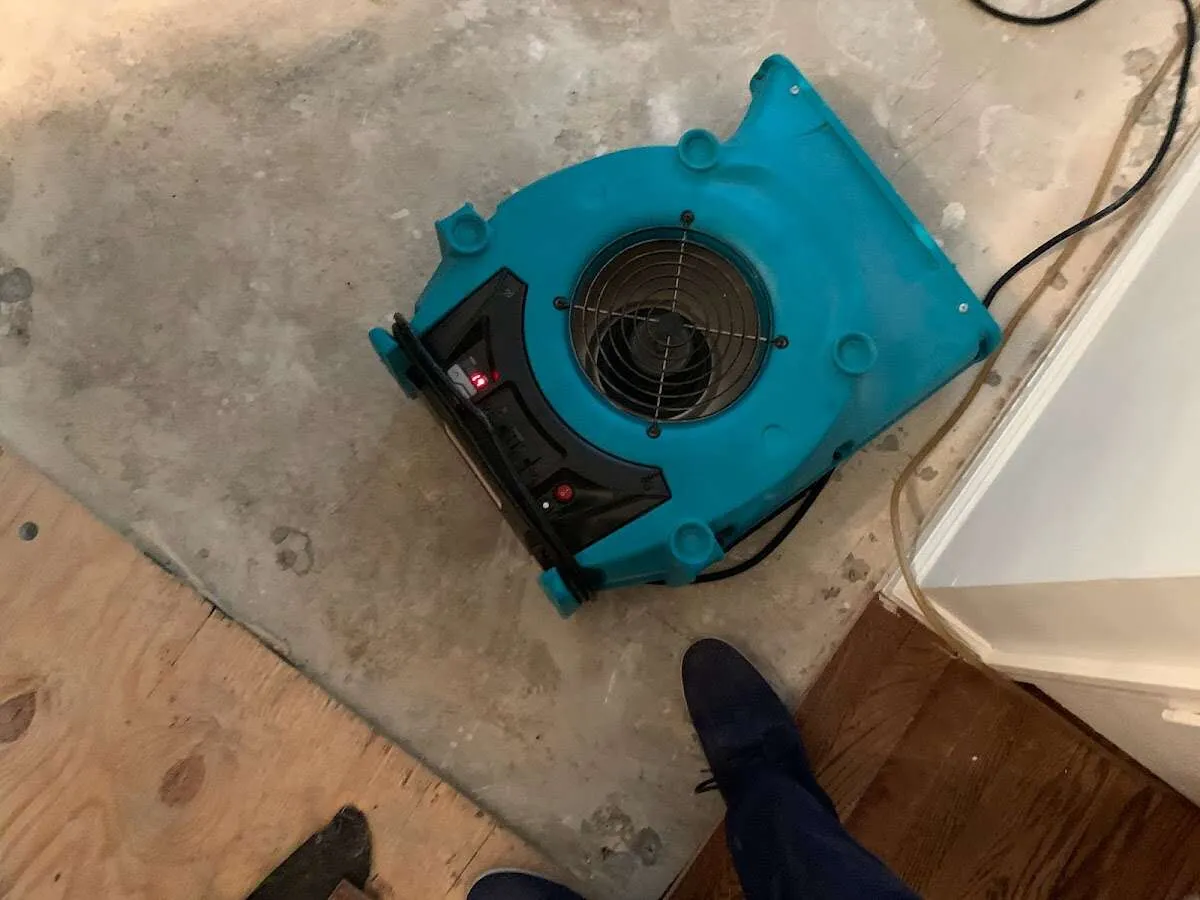 Air mover drying subfloor during Leak Detection & Repair in Almena